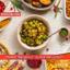 roasted brussel sprouts with bacon in a bowl, alongside other holiday dishes